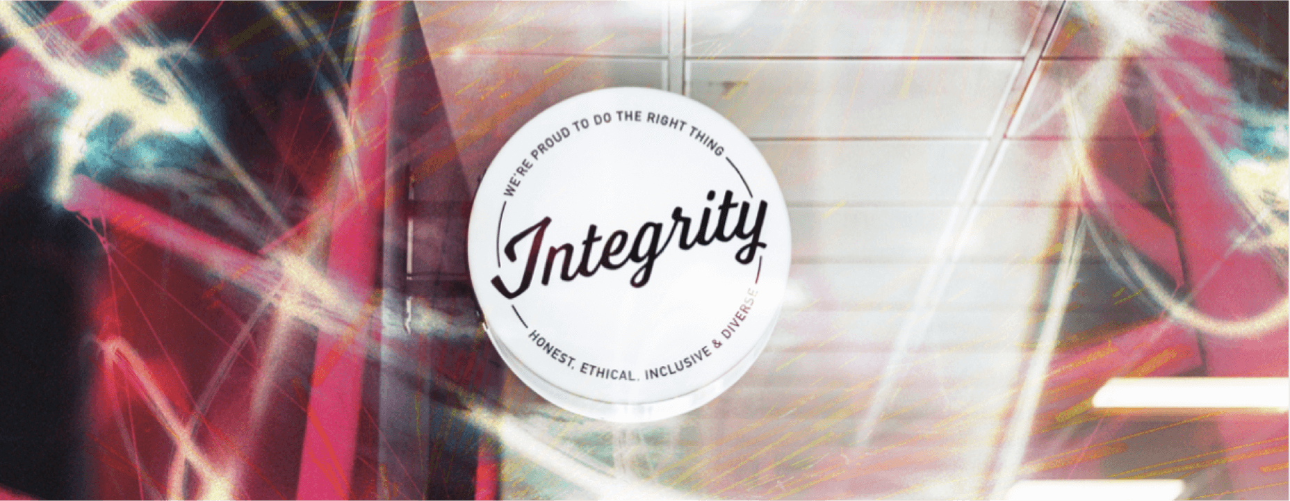 Abstract design with a circular emblem reading "Integrity" and "We're proud to do the right thing," featuring dynamic light streaks.