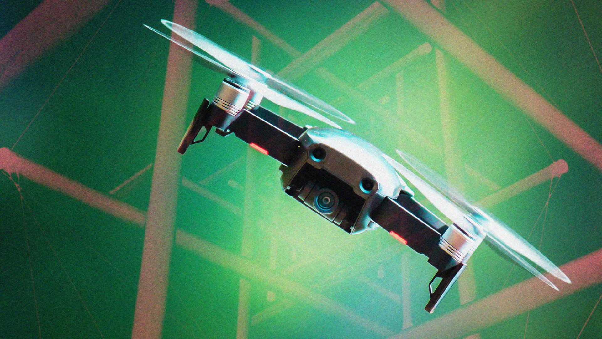 A drone with spinning propellers flying against a green, abstract background with geometric patterns.