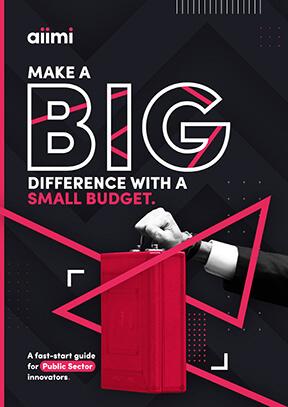 Cover of a guide titled "Make a Big Difference with a Small Budget" featuring a hand holding a red briefcase on a geometric black background.